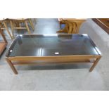 A teak and glass topped coffee table