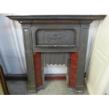 An Art Nouveau cast iron fire insert