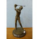 A bronze figure of a golfer