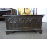 A Gothic Revival carved oak blanket box