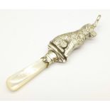 A silver dog rattle, Birmingham 1914