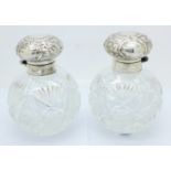 A pair of silver and cut glass globular scent bottles