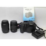 A Canon EOS 20D DSLR, Canon f3.5-5.6 28-80mm zoom, Canon 80-200mm zoom, battery charger, manual