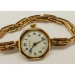 A lady's 9ct gold cased Rolex wristwatch on a 9ct gold expanding bracelet strap, the movement and