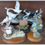A collection of five bird figures including Border Fine Arts and a larger figure group