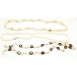 Two freshwater pearl necklaces and a pearl and garnet necklace