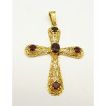 An 18ct gold cross pendant set with garnets, 5.7g