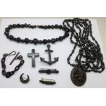 A collection of Whitby jet, four brooches, an Albert necklace, a pendant on beads and a cross a/