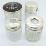 Two silver topped hair tidies, a silver and tortoiseshell lidded jar and one other silver topped