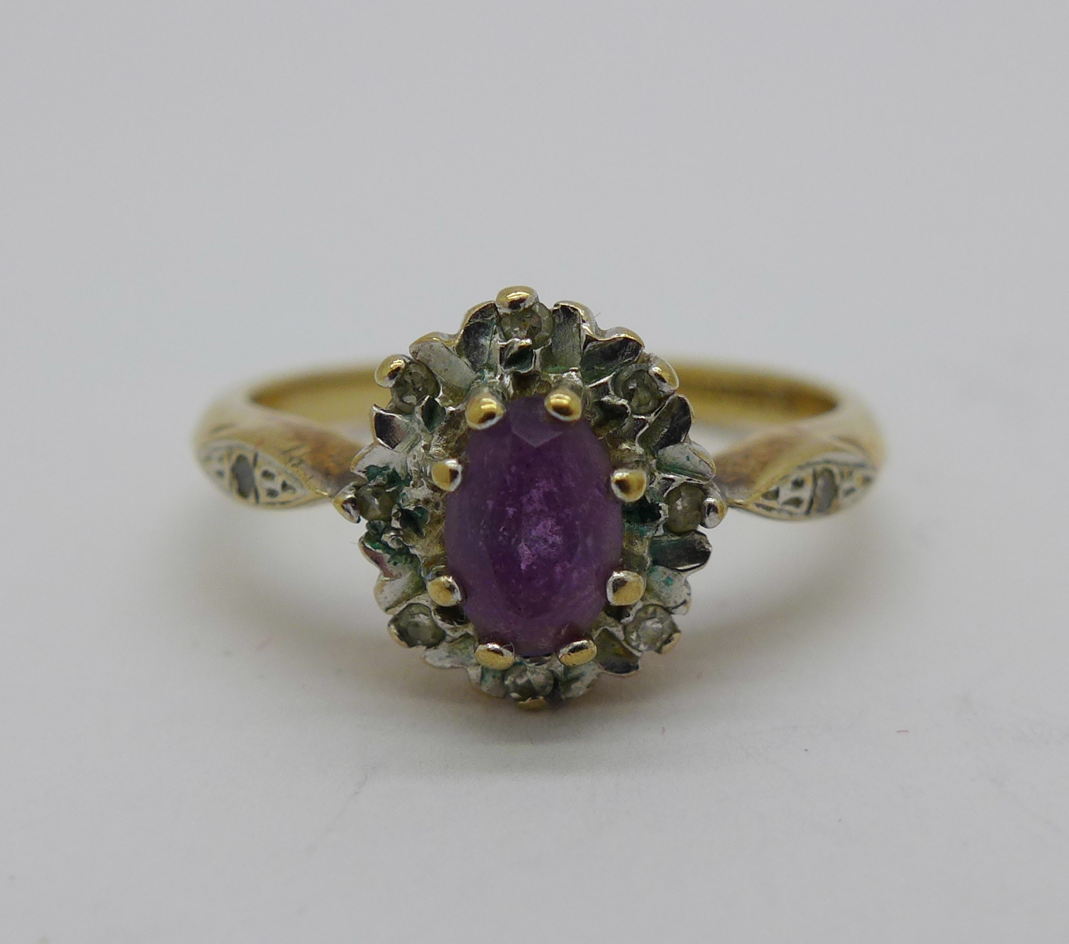 A 9ct gold, purple stone and diamond cluster ring, 2.5g, N