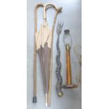 Two canes, one with carved dog's head, an oak table lamp base, an antler handled toasting fork and