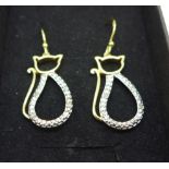 A pair of silver gilt cat earrings with diamond accents