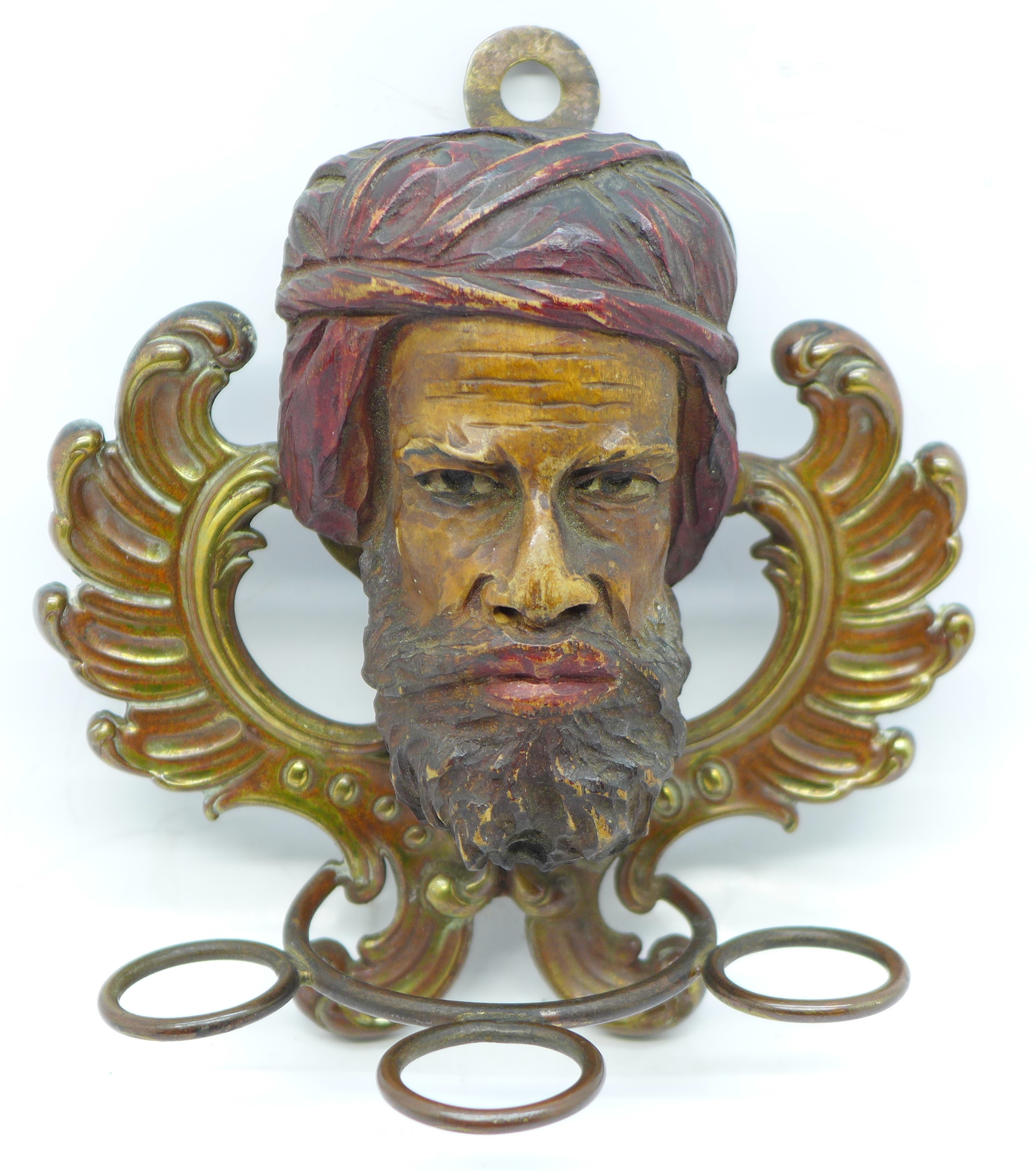 A Moor's carved wooden head and pipe holder
