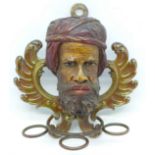 A Moor's carved wooden head and pipe holder