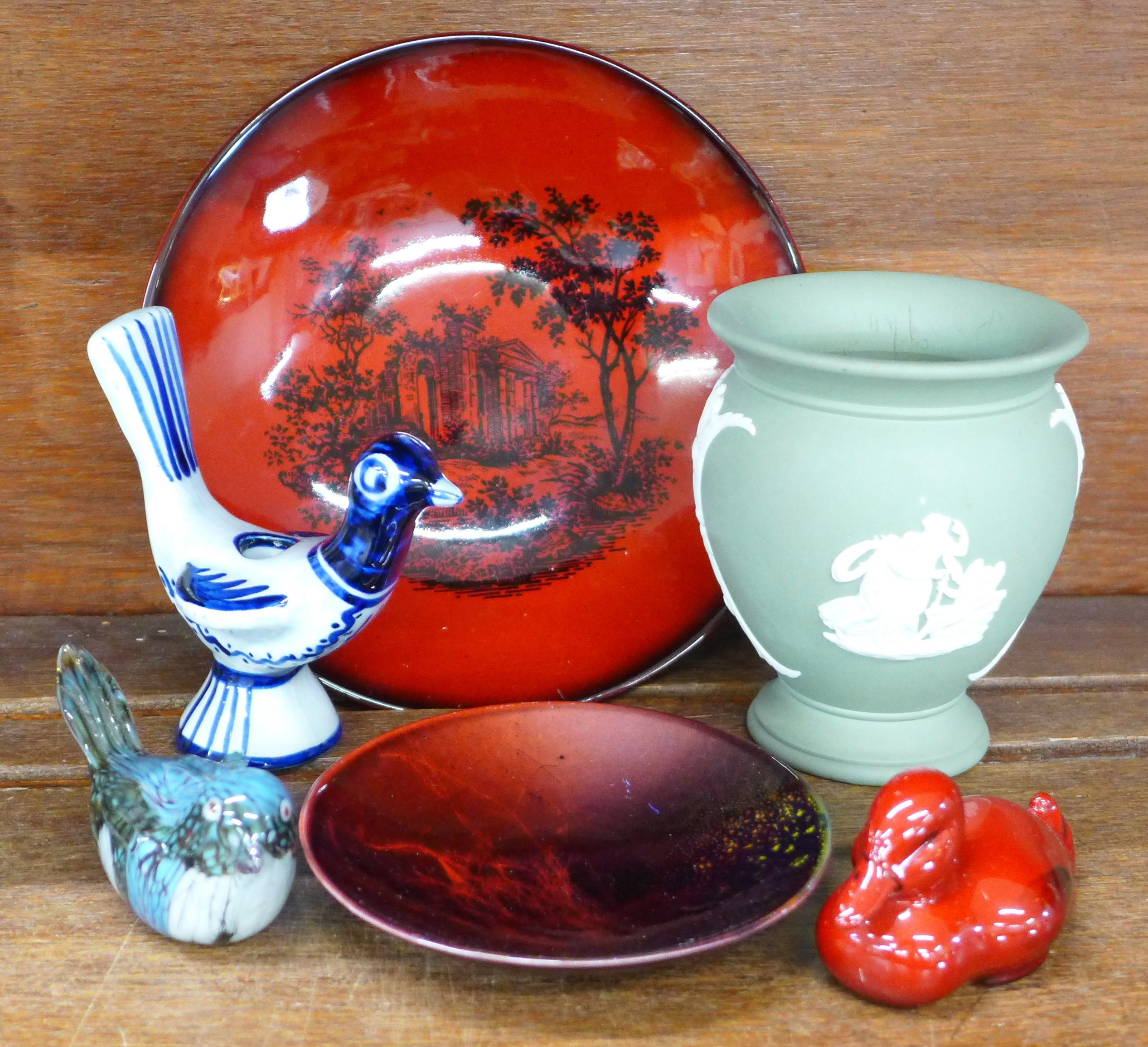 A Royal Doulton flambe plate, pin dish and seated duck, a Wedgwood urn, a Soholm, Denmark bird and