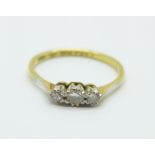 An 18ct gold and platinum three stone diamond ring, 1.6g, M