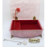 A lucite musical box with a brooch and pendant