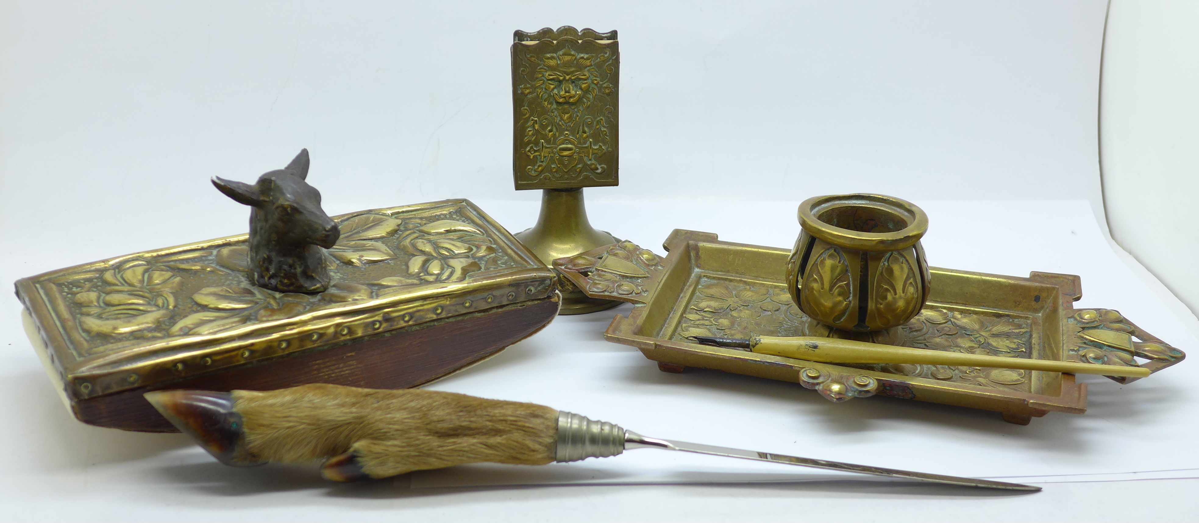 A brass inkwell, a brass blotter, a letter opener and match box holders