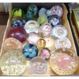 A collection of twenty-two glass paperweights