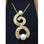 A 9ct gold, pearl and gem set pendant on a fine 9ct gold chain, 6.1g