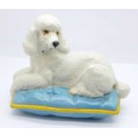 A Royal Doulton model of a poodle laying on a cushion