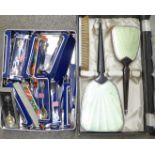 An Art Deco dressing table set, boxed and 22 silver plated souvenir teaspoons