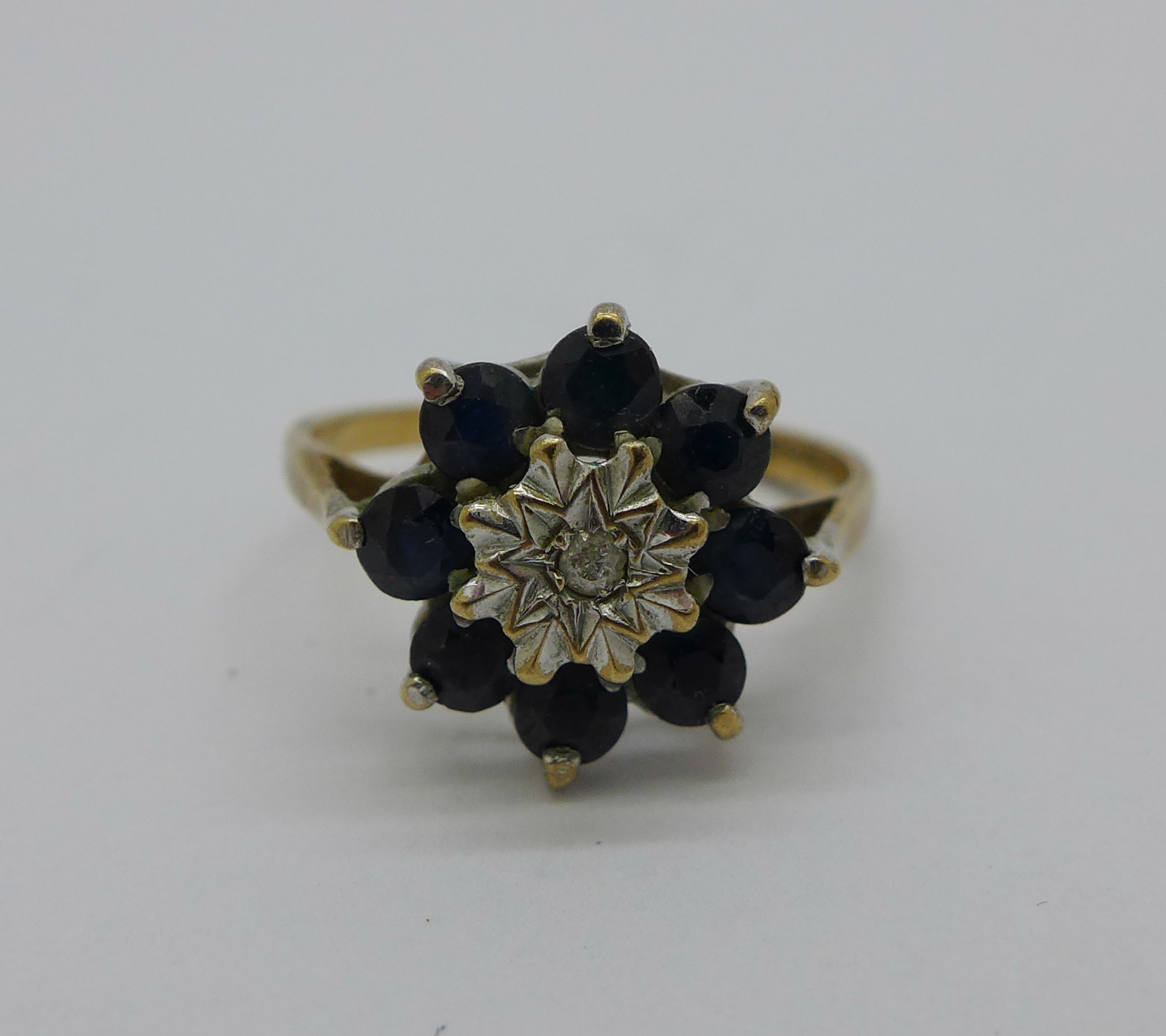 A 9ct gold, diamond and sapphire cluster ring, 2g, K