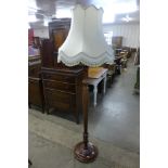 A carved walnut standard lamp
