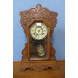 A 19th Century American carved beech gingerbread shelf clock by Ansonia Clock Co.