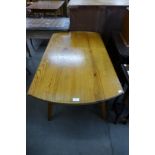 An Ercol pine drop-leaf table