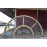 A pair of Art Nouveau style arched stained glass windows