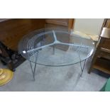 A steel and glass topped circular coffee table