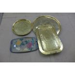 Two Indian brass circular trays, a brass two handled tray and a plastic tray