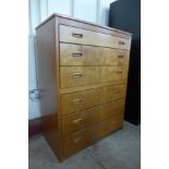 A teak chest of drawers