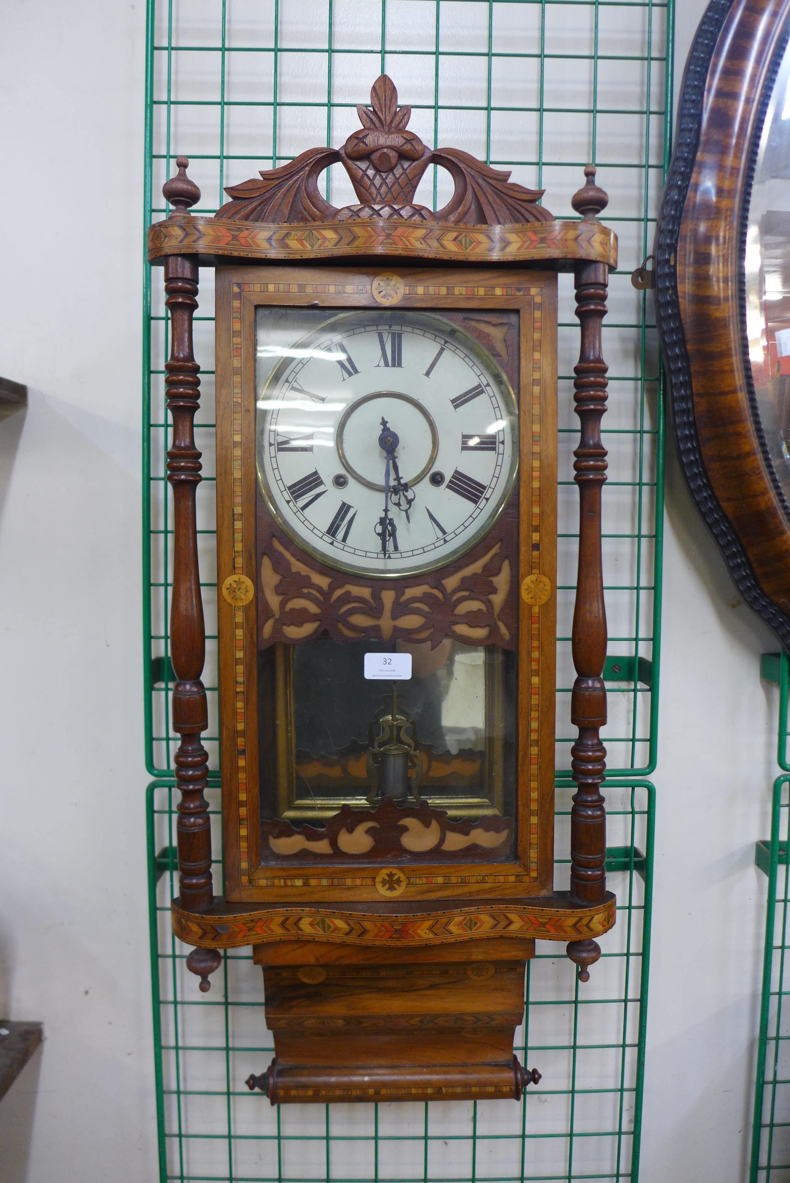 A 19th Century American inlaid walnut 8-day wall clock by E. Ingraham & Co., Bristol, Conn.