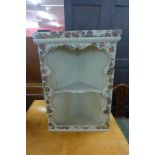 A painted hanging corner cabinet