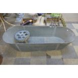 A galvanised bath and stool