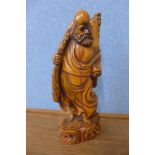 An oriental carved wood figure of a sage