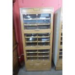 A mid-20th Century fitted oak habadashery shop cabinet