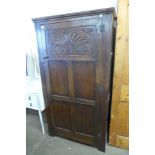 A 17th Century style carved oak wardrobe