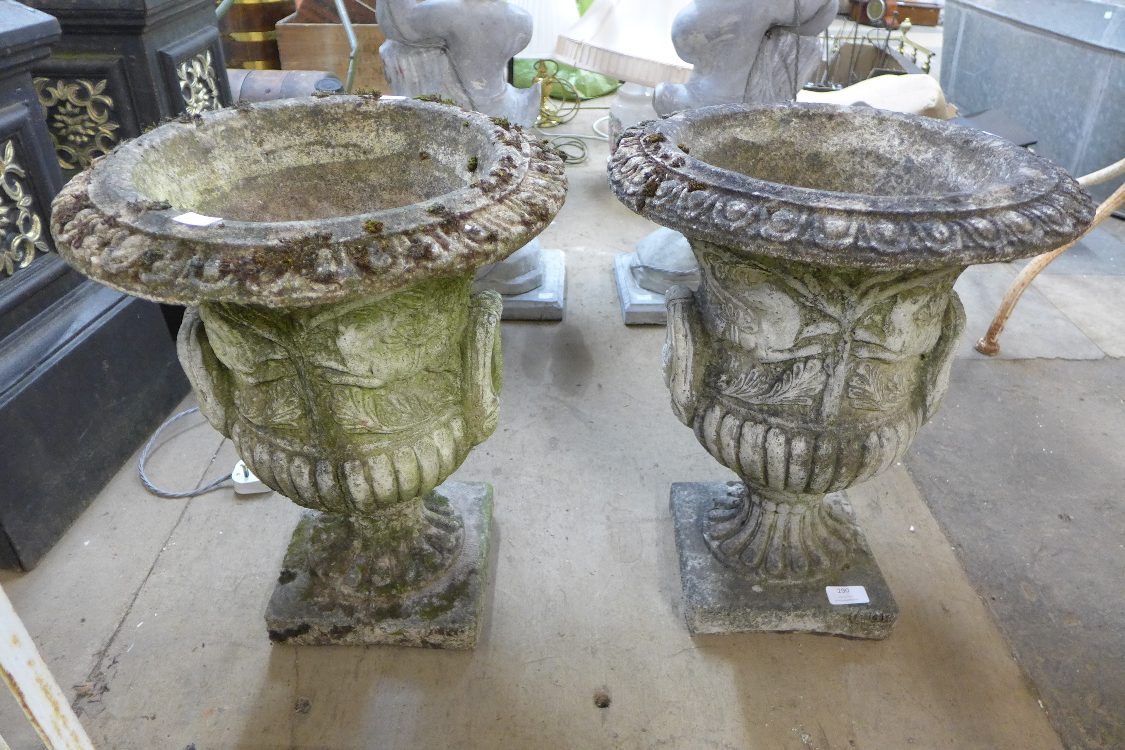 A pair of concrete campana shaped garden urns