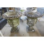 A pair of concrete campana shaped garden urns