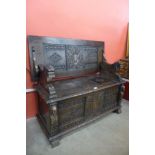 A 17th Century style carved oak monk's bench