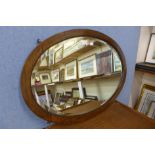 An oak framed oval mirror