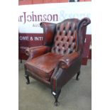 A red leather wingback armchair