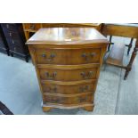 A small yew wood serpentine chest of drawers