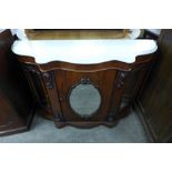 A Victorian walnut and marble topped serpentine credenza