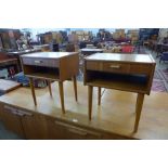 A pair of teak bedside tables