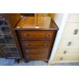 A small inlaid mahogany chest of drawers