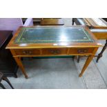 A yew wood three drawer writing table